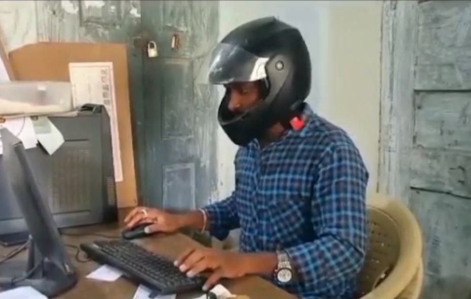 employees wear helmets while riding bikes in this government office