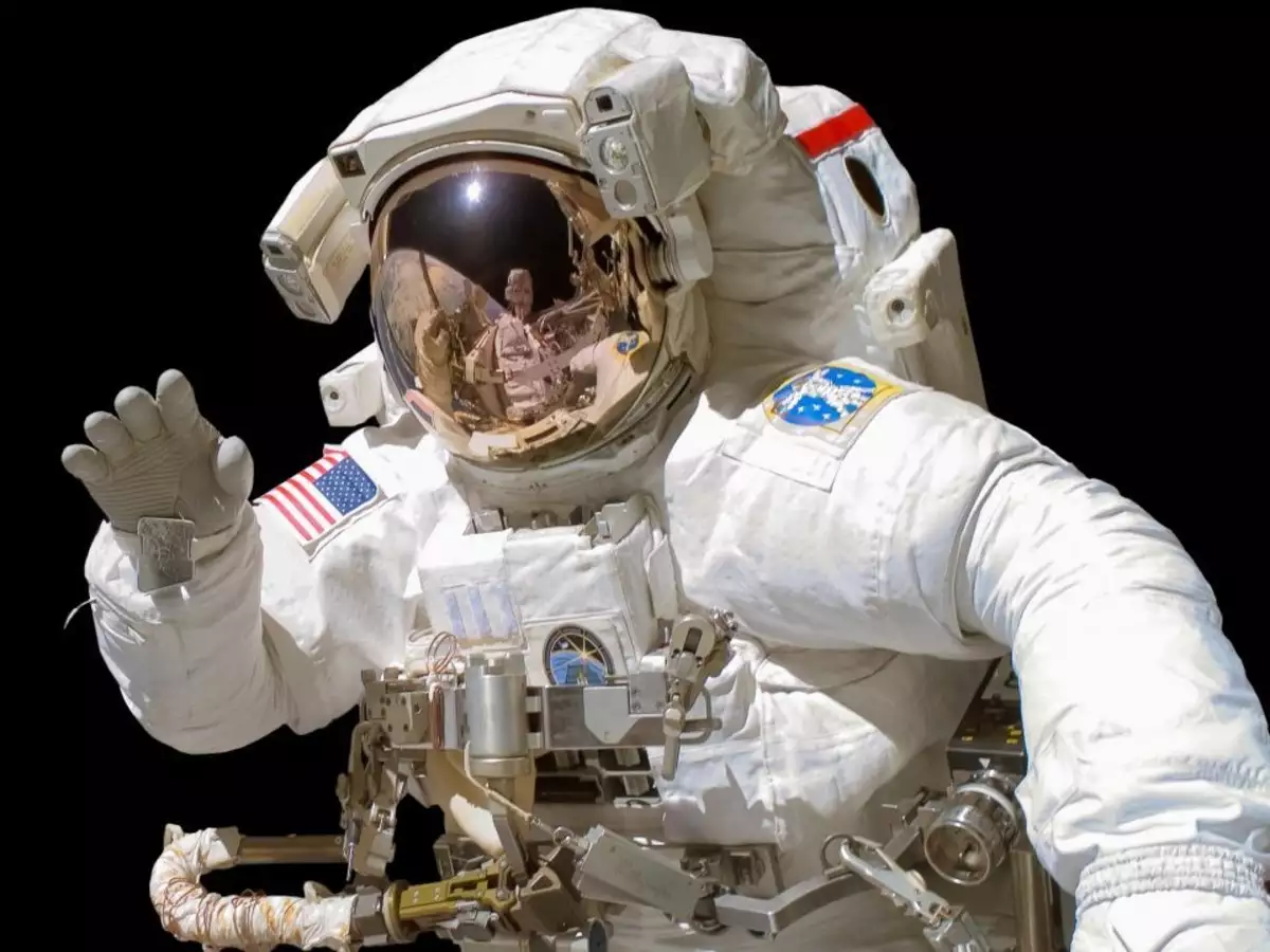 why do astronauts wear two types of space suits orange and white 2